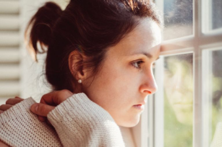 Woman looking out of window