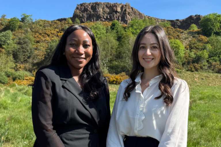 Theresa Mutapi and Rona Hayworth (Digby Brown's newly promoted Partners) standing at the base of Arthur's Seat in Edinburgh