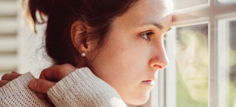 Woman looking out of window