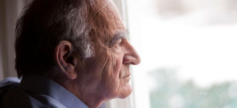 Older Man Looking Out Window