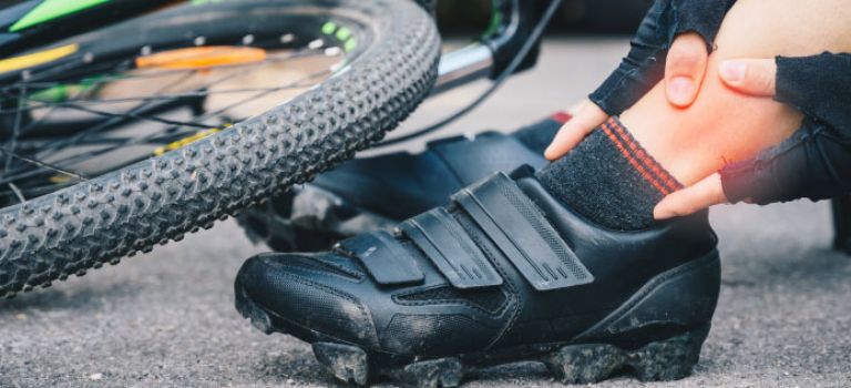 Cyclist sitting in road after being knocked off bike